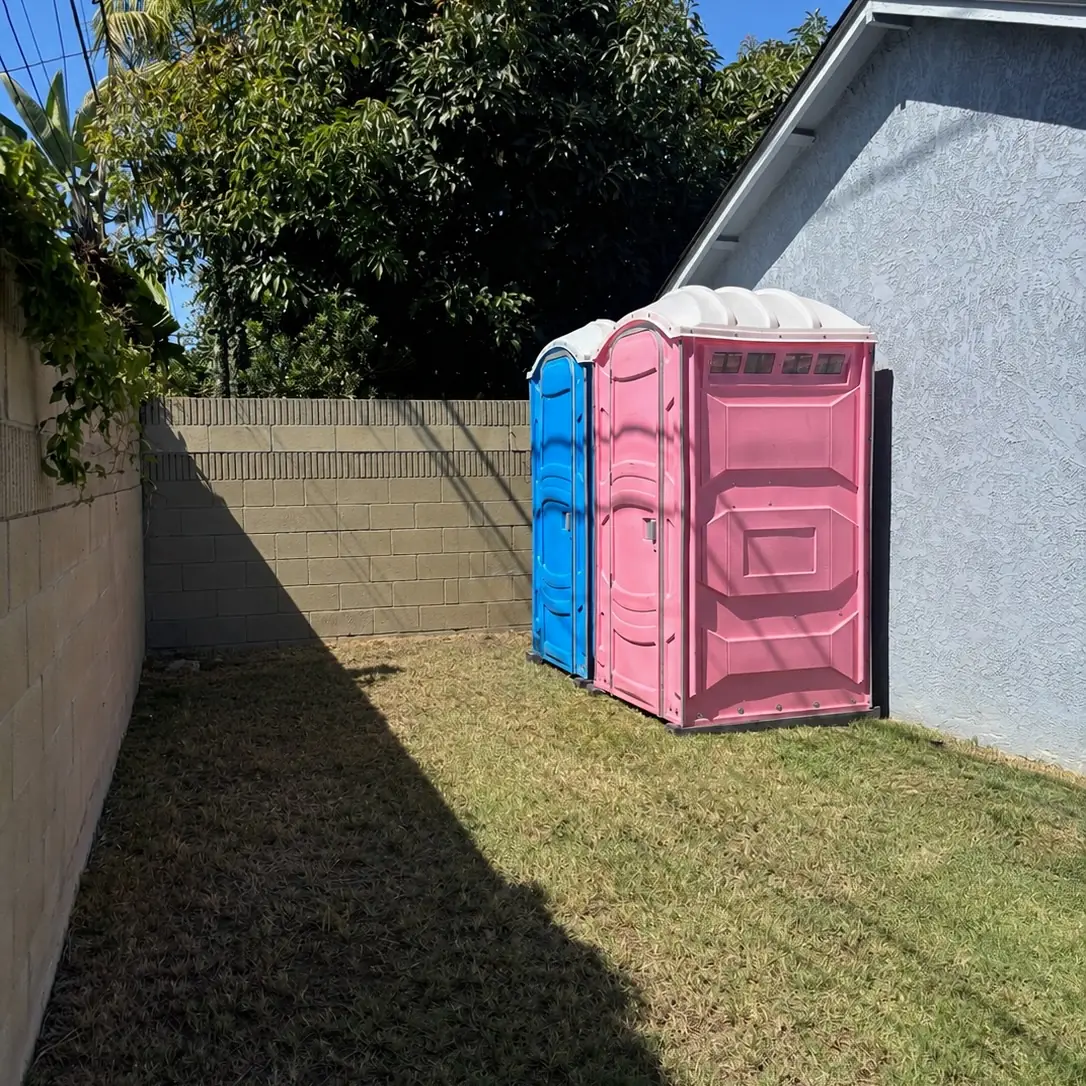 Pink PJN3 unit on a lawn beside a house with a blue unit behind it